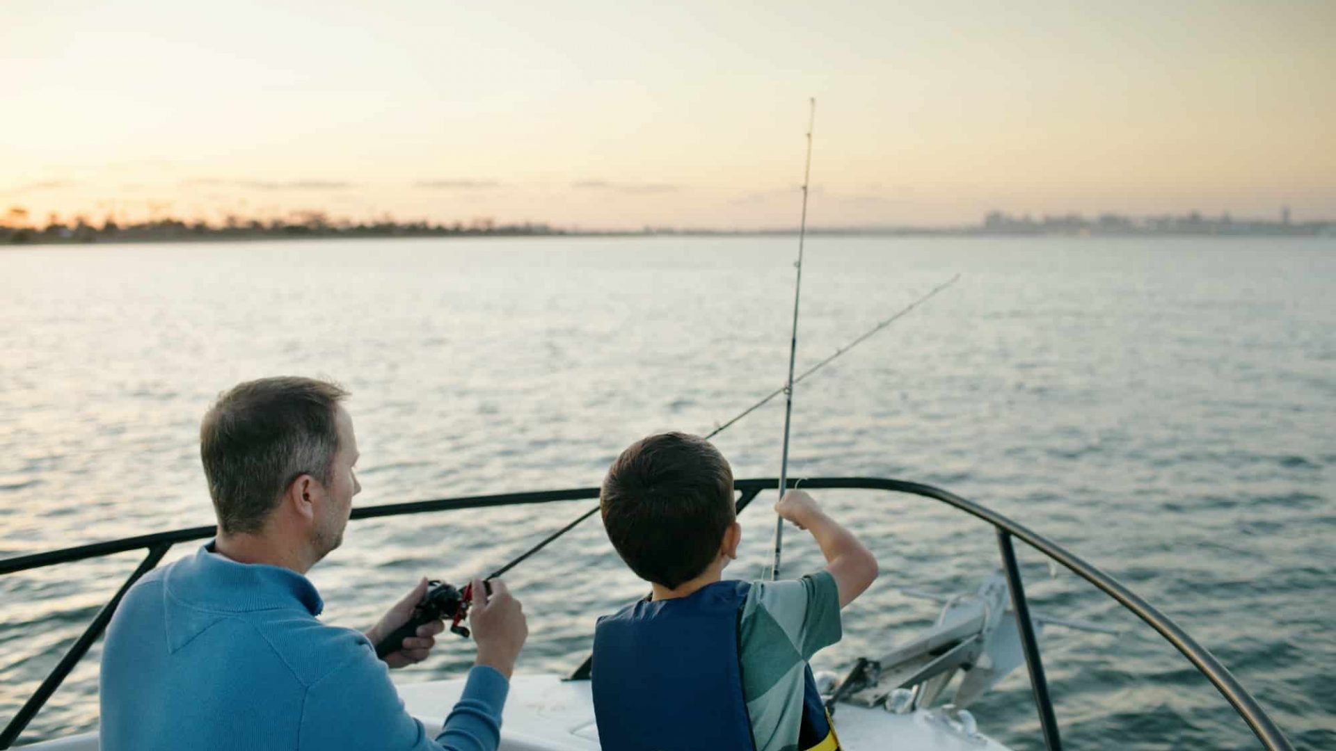 Father And Son Fishing On Boat